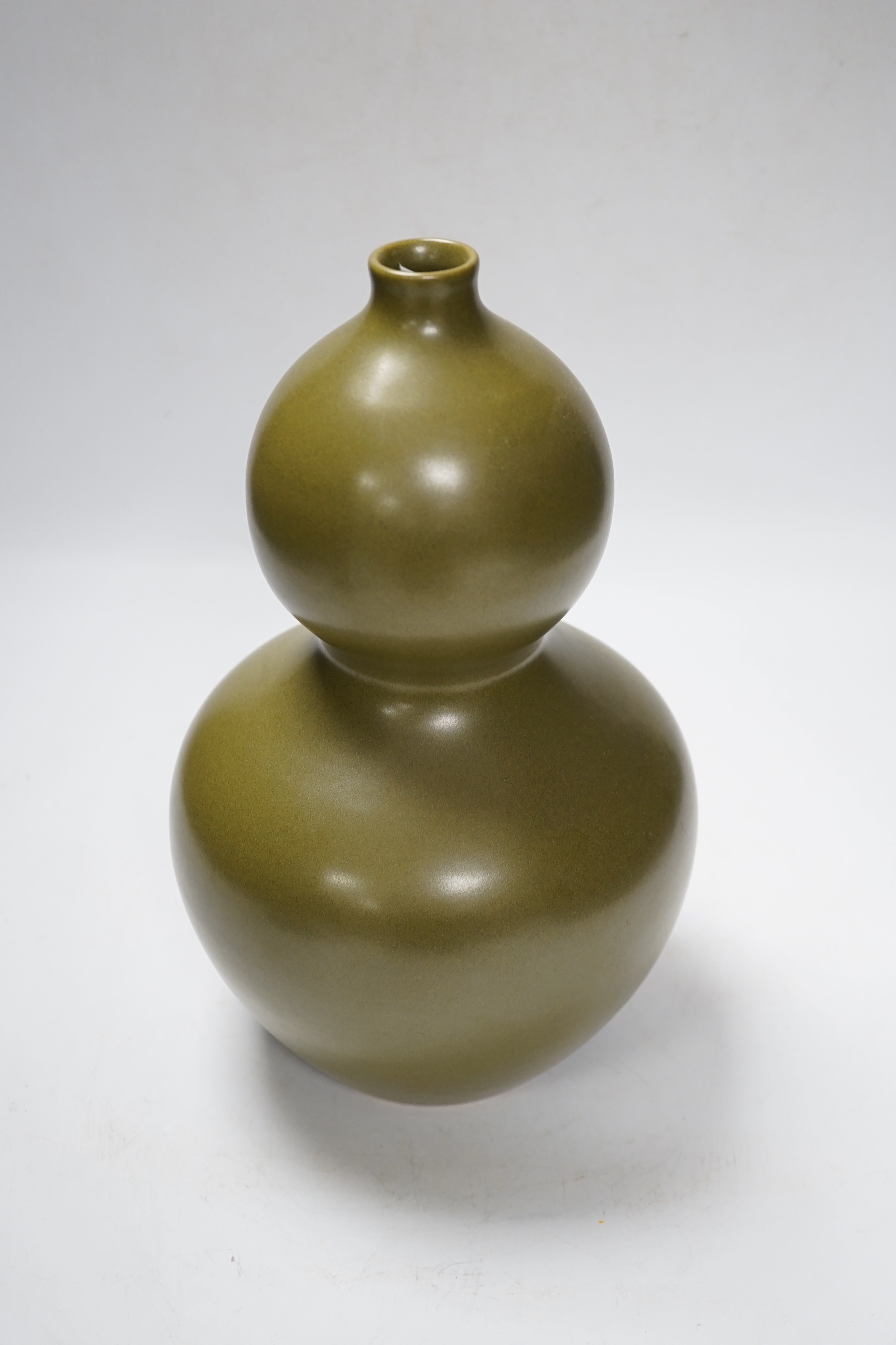 A Chinese olive-green double gourd vase, 29cm high